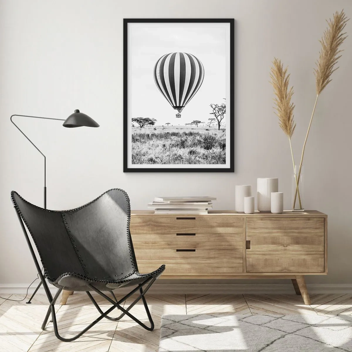 Poster in black frame - A hot air balloon floating over the savannah in black and white. - 50x70cm - Over the Savannah - Modern wall decoration for the living room and bedroom ARTTOR