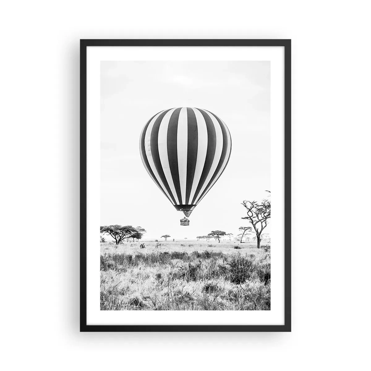 Poster in black frame - A hot air balloon floating over the savannah in black and white. - 50x70cm - Over the Savannah - Modern wall decoration for the living room and bedroom ARTTOR