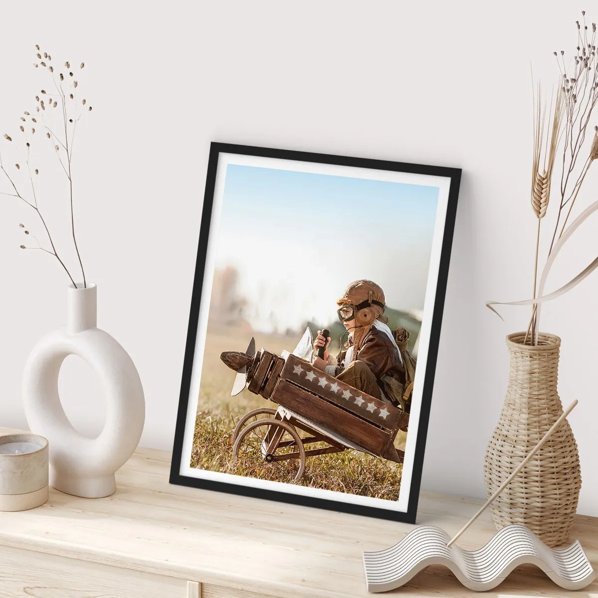 Poster in black frame - A child in a wooden airplane with stars in the background - 50x70cm - Take off for a Dream - Modern wall decoration for the living room and bedroom ARTTOR