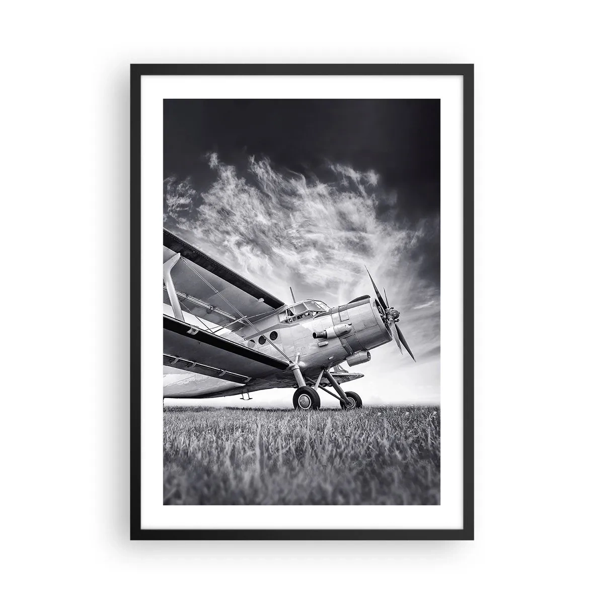 Poster in black frame - A black and white image of an airplane against a dynamic sky. - 50x70cm - Winged Pilgrim - Modern wall decoration for the living room and bedroom ARTTOR