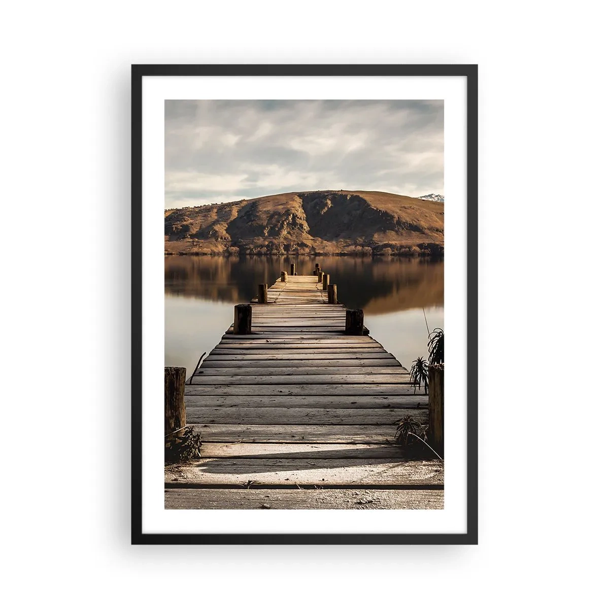 Poster in black frame - A wooden jetty leads to a tranquil lake with a mountain backdrop - 50x70cm - Landscape in Silence - Modern wall decoration for the living room and bedroom ARTTOR